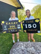 Kailey Maskerines, left, and Paige Fava celebrate milestones at the Passaic County Tournament girls lacrosse semifinal game Wednesday, May 8. (Photos provided)