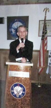 Ted Hajek Jr., currently president of the Upper Greenwood Lake Volunteer Ambulance Corps, speaks at an anniversary event some years ago. He began helping the squad when he was 15 and continues to serve. Photos by Ann Genader.