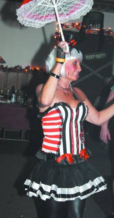 Elks Halloween dance is a real scream Tight rope walker, Debby Valeri, balances her way around the dance floor.