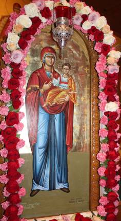 A celebration of Mary The icon of Santa Maria in the chapel is bedecked by flowers for the day of honoring the mother of Jesus.