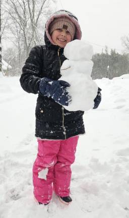 9.5 inches of snow reported SN2 Olivia Padilla holds a miniature snowman. (Photos by Rich Adamonis)