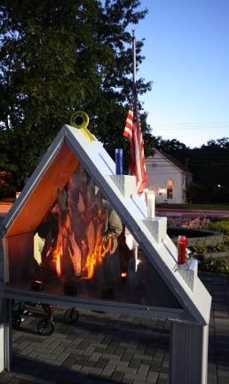 They gathered in honor and respect The American flag is flown at half mast in memory of the victims of the terrorist attacks of 9/11/01. The flames were burning in the memorial, constructed from a beam from one of the Twin Towers. The beam artifact was installed last year on the 10th anniversary of 9/11. For more photos from the ceremony, go to westmilfordmessenger.com.