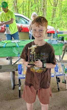 ‘Fishing and family fun’ A young fisherman with a trophy.