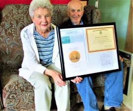 Peter Gillen Jr. and Patricia Gillen hold framed documents from Bishop Arthur Serratelli of the Roman Catholic Diocese of Paterson recognizing their lifelong volunteerism at St. Joseph parish at Echo Lake. Photo by Ann Genader