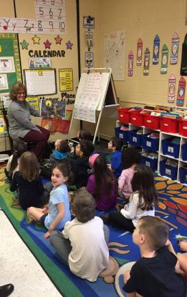 West Milford celebrates 'Read Across America' Dr. Joan Oberer, former principal of Westbrook Elementary School, shares a favorite book with young students.