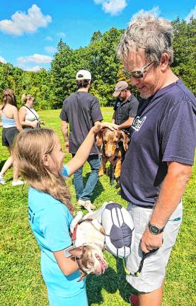 Dog Walk raises money for shelter Glenn Liebau’s dog attracts an admirer. Liebau is co-owner of 4Twenty Somewhere, a sponsor of the Dog Walk.