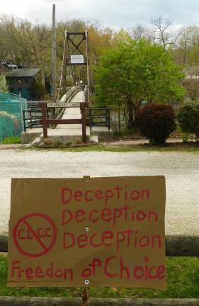 A protester's sign near the Lake Cranberry footbridge. (Photo by Mandy Coriston