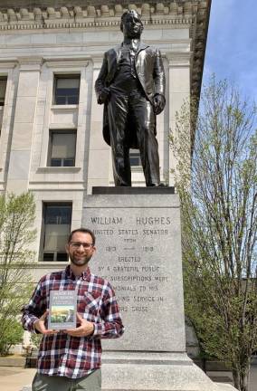 Local author is finalist in American Book Fest contest Dan Willever stands before a statue of the late U.S. Sen. William Hughes in front of the Passaic County Courthouse in Paterson. (Photo provided)