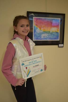 Ella Brannan stands beside her artwork.