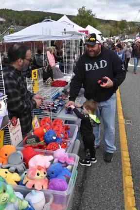 James Iovino, with his son, Nick, found the perfect toy truck to buy at the Autumn Lights Festival. (Photo by Rich Adamonis)