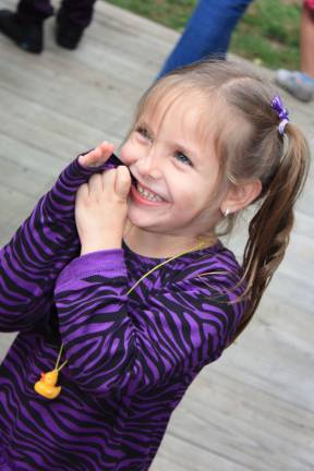 It was smooth sailing for the ducks Three-year old Giana Krupka had the duck necklace and came close to the big duck mascot, but then all she could do was keep her distance and giggle. And chew on her sleeve. Photo by Ginny Raue