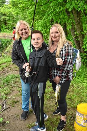 ‘Fishing and family fun’ Reiley Brand celebrates his catch with his family.