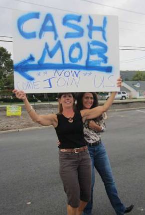 The Cash Mob strikes again Michele Giannattasio recruits shoppers for the Cash Mob last Saturday. With her is Wendy Watson-Hallowell of Sustainable West Milford.
