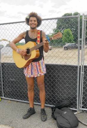 Motorists exhibit camaraderie on crazy-long lines at the DMV Matt Graney plays the guitar. (Photo by Vera Olinski)
