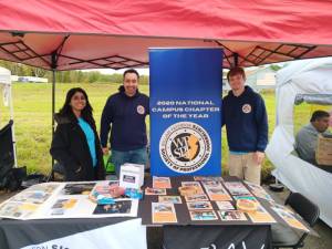 Patrick Groh, right, of West Milford mans a tent at the Autumn Lights Festival in October with Susmita Majumder and Nick Hirshon. Groh is vice president of the William Paterson University chapter of the Society of Professional Journalists. Majumder is a member and Hirshon is the chapter adviser. (Photo provided)