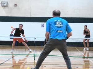 Rich Lenihan returns the pickleball in an intermediate-level match Saturday, April 13 at the Recreation Center. He was playing with Nicole Rydzewski against Jim and Nancy Zajdel. (Photo by Kathy Shwiff)