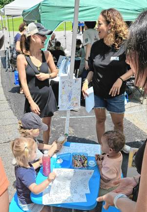 Community Day features street fair Young children color during Community Day.