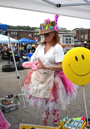 Community gathers for National Night Out Barbara Mazgy-Di Pasquale, also known as Kandy the Clown, makes a balloon figure.