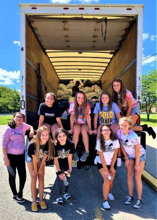 Cheerleaders gather 3,700 lbs of clothing during recent drive