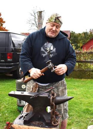 Bill Barrett shows off his prized hand-forged hammer.