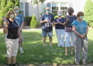 The outdoor singers meet up in the Courtyard at the Bald Eagle Commons Senior Citizen Community each evening - wearing their masks and maintaining social distancing requirements - and prepare to sing “God Bless America” together precisely at 5 p.m. Photos by Patricia Keller.