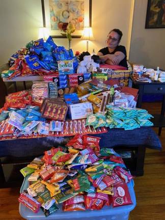 Kisha Acevedo with goods to be donated to the local homeless population. Items were organized were packed into easy-to-carry drawstring bags.