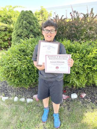 Raymond Obidzienski shows off his awards.