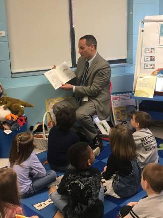 West Milford celebrates 'Read Across America' Superintendent of schools Dr. Alex Anemone had a group of students enthralled as he read to them