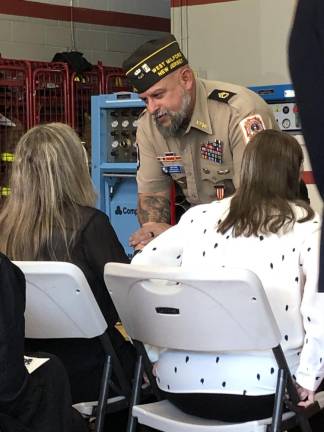 Rudolf Hass, commander of Veterans of Foreign Wars Post 7198, gives his condolences to Michelle Steines before the service.