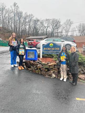 Passaic County Technical Institute students Aleksandra Szymanska, Angel DeLos Reyes and Fatihah Ahmed pose with one of the Little Free Libraries that they are donating to various locations. (Photo provided)