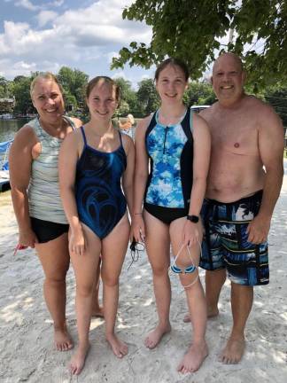 Going the distance The whole Kaminsky family swam the distance event. Michele, left, coaches her twin daughters, Kelsey and Kayleigh, right, on a summer swim team. Michelle and Shawn were ‘buddies’ for the 14-year-old girls, who finished second and fourth, respectively. (Photo by Kathy Shwiff)