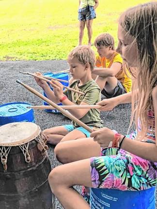 West African drumming lesson DR3 Campers practice West African drumming.