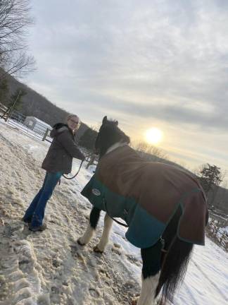 Helping Hippotherapy Madeline Williams with a therapy horse at Winslow Therapeutic Riding Center in Warwick