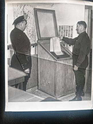 Looking back: Early police communications West Milford Police Chief John Moeller, left, and Capt. Jack Ryan check the teletype machine at Police Headquarters. which was in the balcony of the current West Milford Museum, in the early 1950s. (File photo by Ann Genader)
