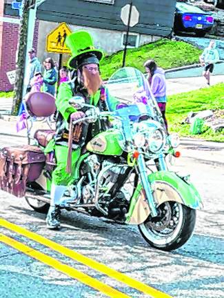 This leprechaun in the Newton parade has a sweet ride. (Photo by Nancy Madacsi)