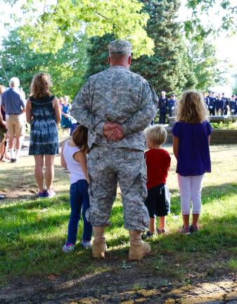 'Find that unity again' Photos by Don Webb The children wore red, white and blue while their dad had on his fatigues at the September 11 commemoration at West Milford on Sunday, Sept. 11.