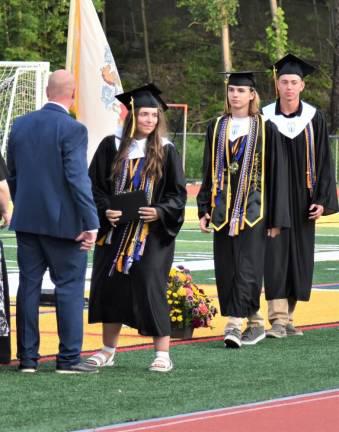 Principal Mathew Strianse presents diplomas to salutatorian Olivia Gallione and co-valedictorians Brandon Scrimenti and Wyatt Space, right. (Photo by Fred Ashplant)