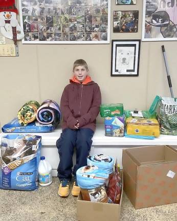 Brayden Bobrowski, 11, of the Oak Ridge Martial Arts Academy collected and donated more than $1,000 in cash, cat and dog food, and treats toward earning his brown belt in karate.