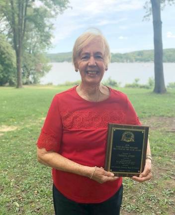 Christel Dygos hold the plaque presented to her as West Milford Volunteer of the Year.