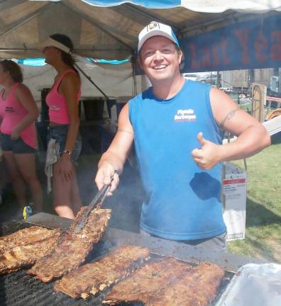 The pitmaster grilling ribs (Photo by Russ Mensch)