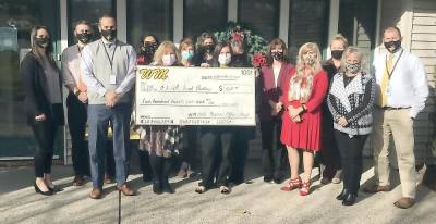 West Milford Township Public School BOE staff members posed for a quick photo with the giant check that was presented to the Food Pantry of Our Lady Queen of Peace Church in Hewitt. for $525. Provided photo.