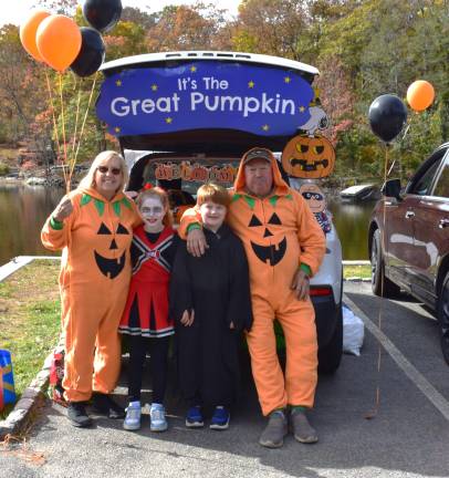UGL Clubhouse hosts trunk or treat Terry and Ted Pannullo gave out helium-filled balloons to everyone that wanted one. They are shown with their grandchildren, Delia and Benjamin.