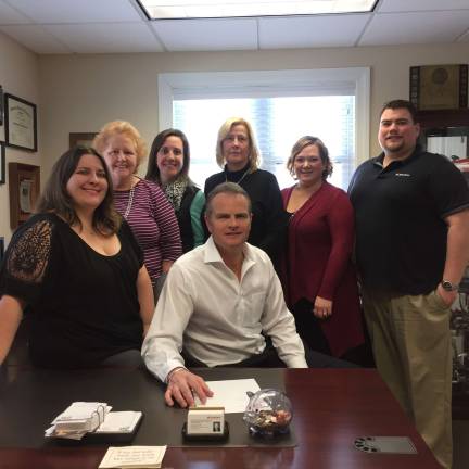 Being a good neighbor for 20 solid years Tom Ziegenbalg, center, is surrounded by his team at State Farm. From left Kelly Gillow, Mary Intile, Lyndsay Wright, Judith Davie, Danielle Sweezy, and David Ziegenbalg.