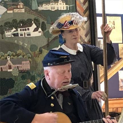 Walt Dewey, leader of the group, plays guitar and harmonica, and Beth Salvatori plays a wash tub bass.