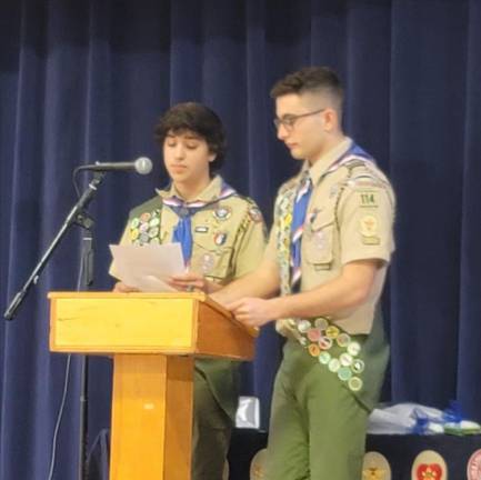 New Eagle Scouts Luke Slifer, left, and Francesco Petrosillo speak at the podium.