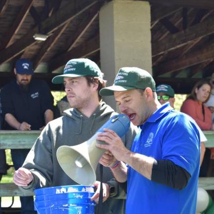 George Christman, left, of the West Milford Recreation Department selects raffle tickets as Daniel Kochakji, community services and recreation director, announces winners of fish-themed prizes at the end of the derby.