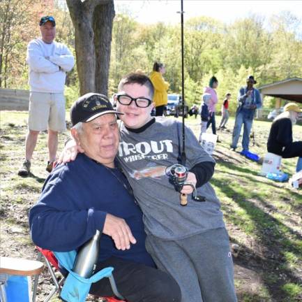 Logan Trout, 13, gets tips on fishing from his grandfather Ray Vanisko, an avid fisherman.