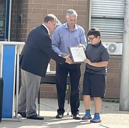 West Milford Elks B.P.O.E. 2236 Exalted Ruler Ken Hensley and Chaplain/Americanism Committee Chair Todd Soltesz present Raymond Obidzienski with awards for his essay.