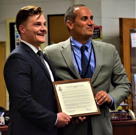 Macopin Middle School History Teacher Robert Callamari, left, holds up his plaque as Teacher of the Year with Schools Superintendent Alex Anemone during Tuesday night's Board of Education meeting. (Connor Murphy photo)