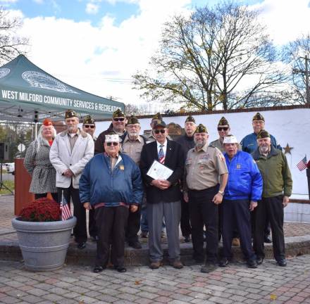 Members of the American Legion and VFW present Glenn Wenzel with a plaque.